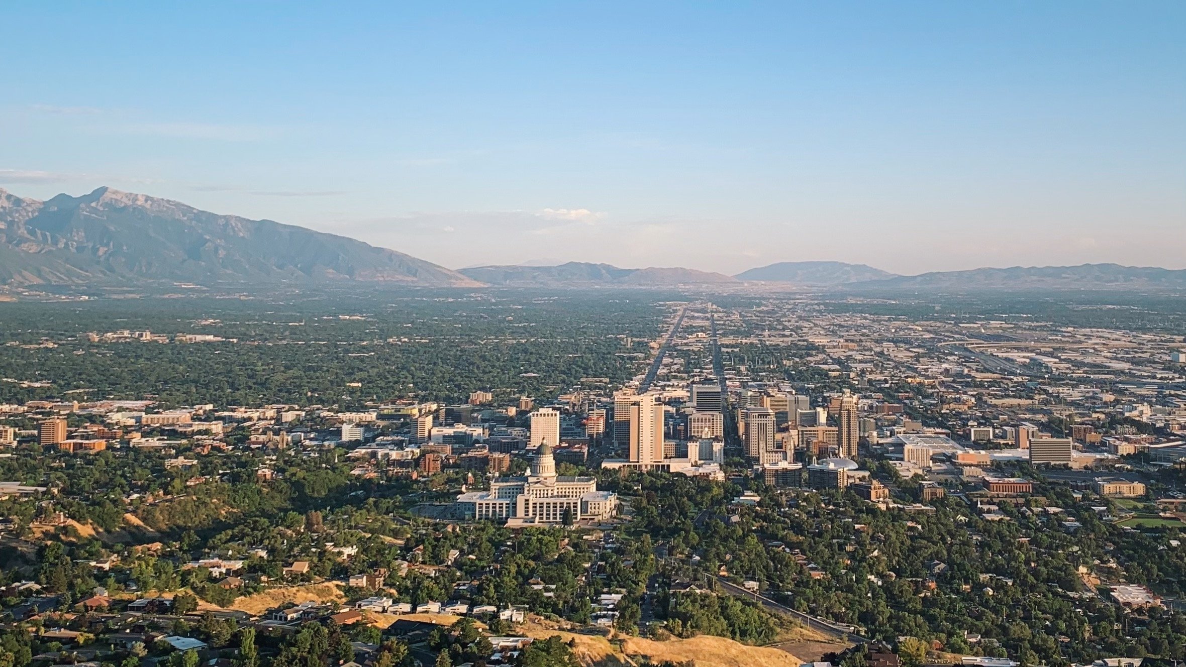 The Utah State Capitol and downtown Salt Lake City on the Bonneville benches, the valley spreading to the Wasatch and Oquirrh ranges — the basin dropped by the Wasatch Fault.