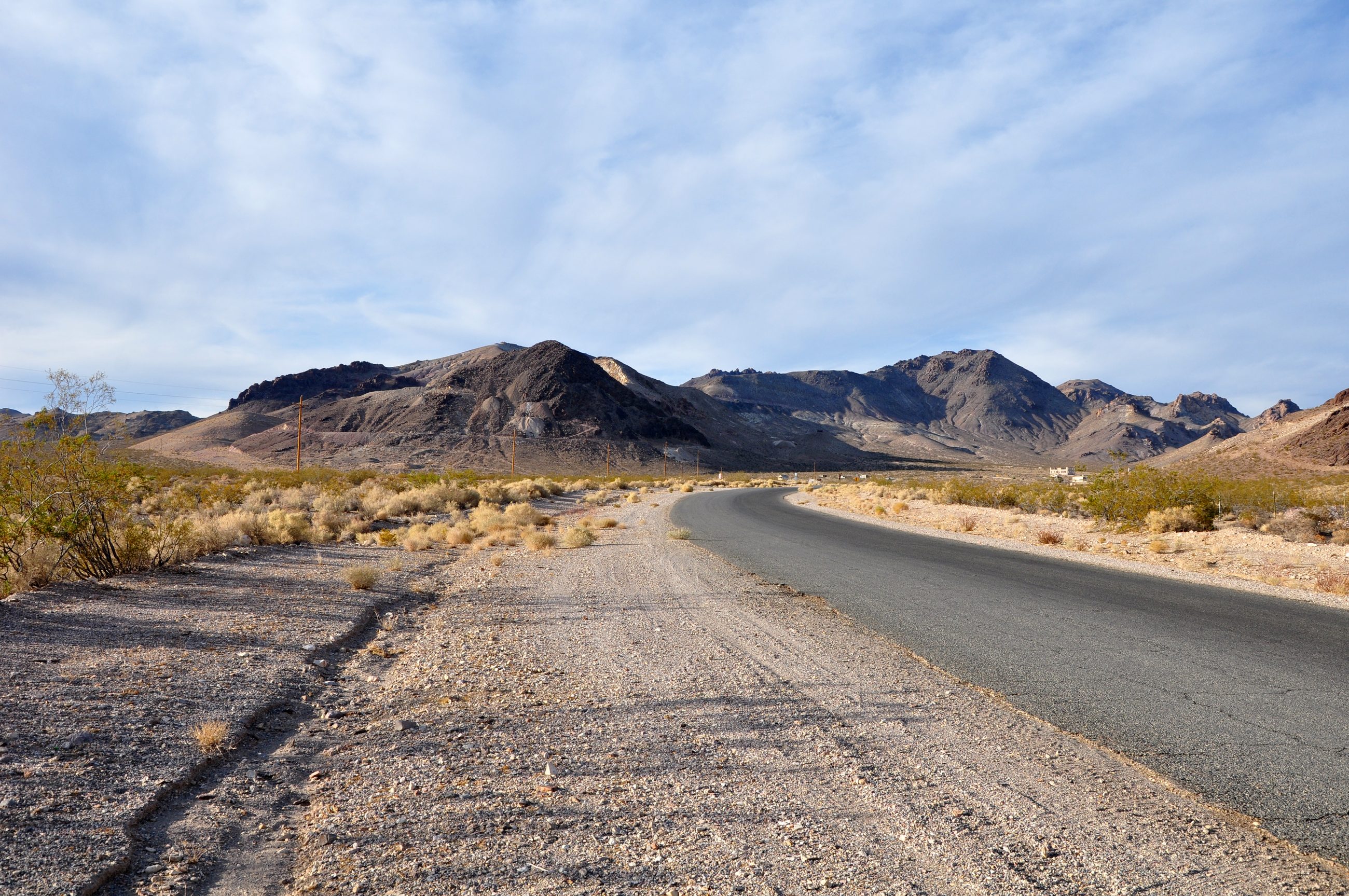 The pale rhyolite volcanic hills of the Bullfrog district in southwestern Nevada, rising along the road to the ghost town of Rhyolite.