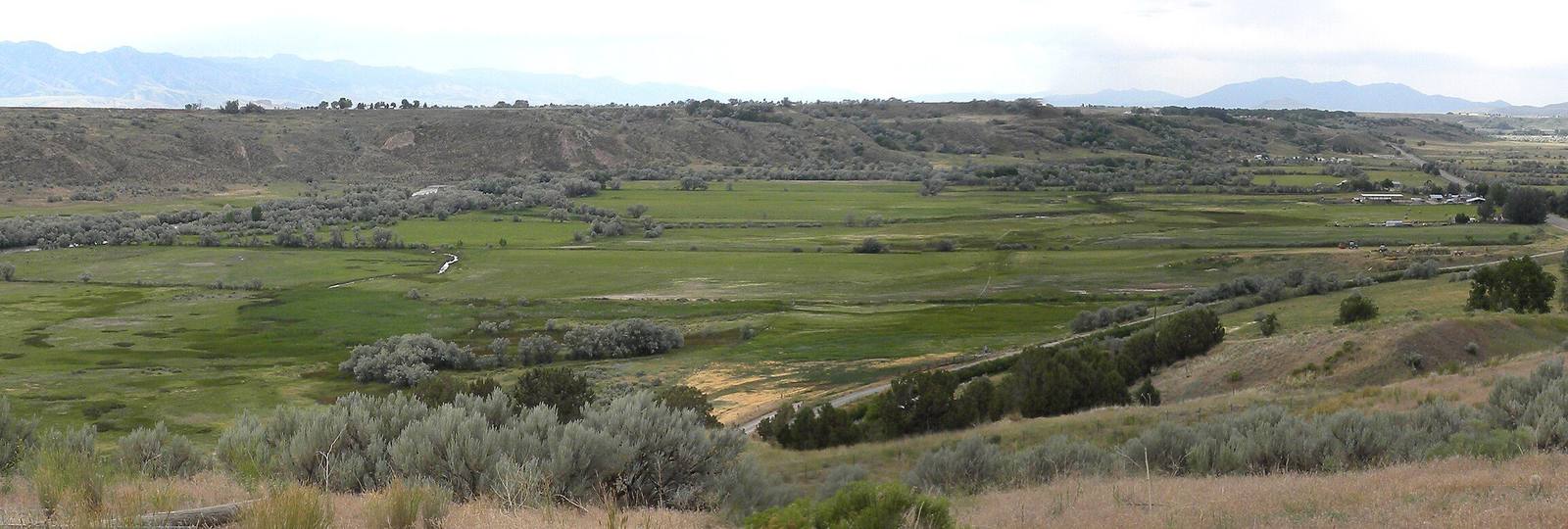The green river bottoms of the Bear River at Boa Ogoi, with sagebrush benches rising beyond