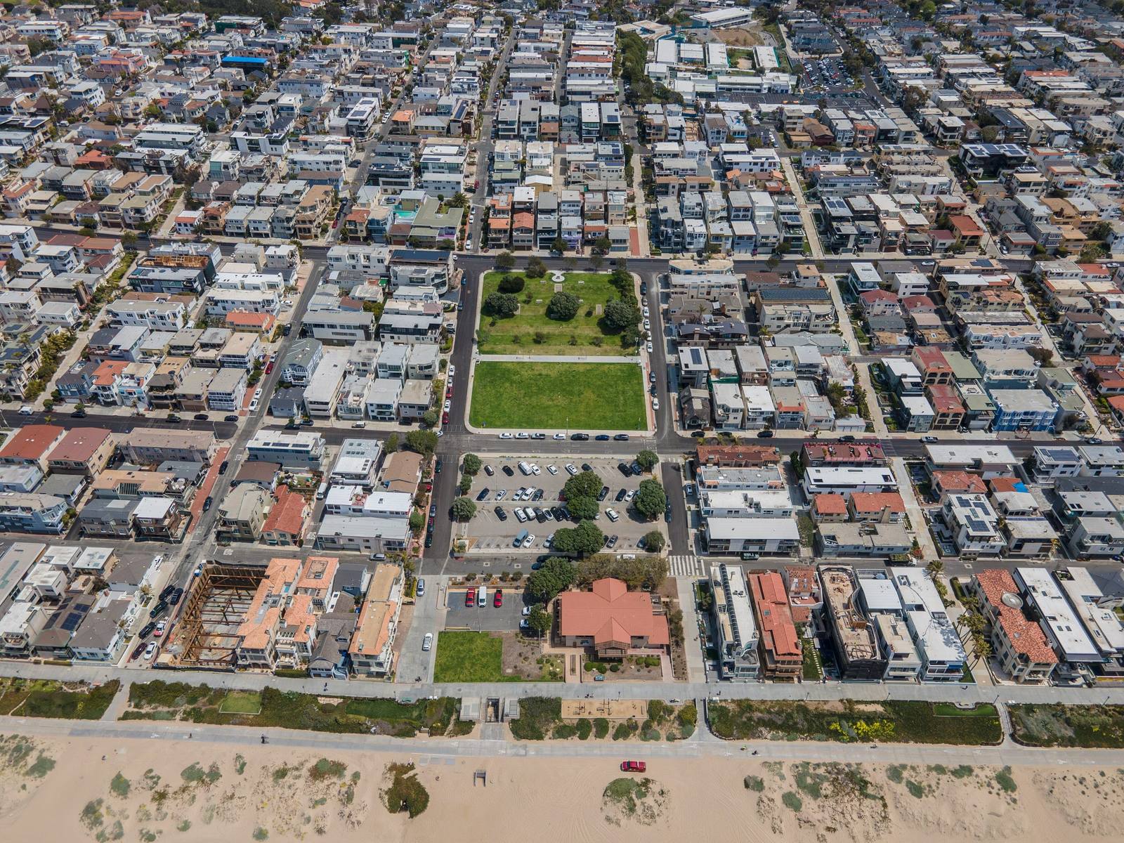 Bruce's Beach in Manhattan Beach from the air, a green park block cut into the grid of houses running down to the sand.