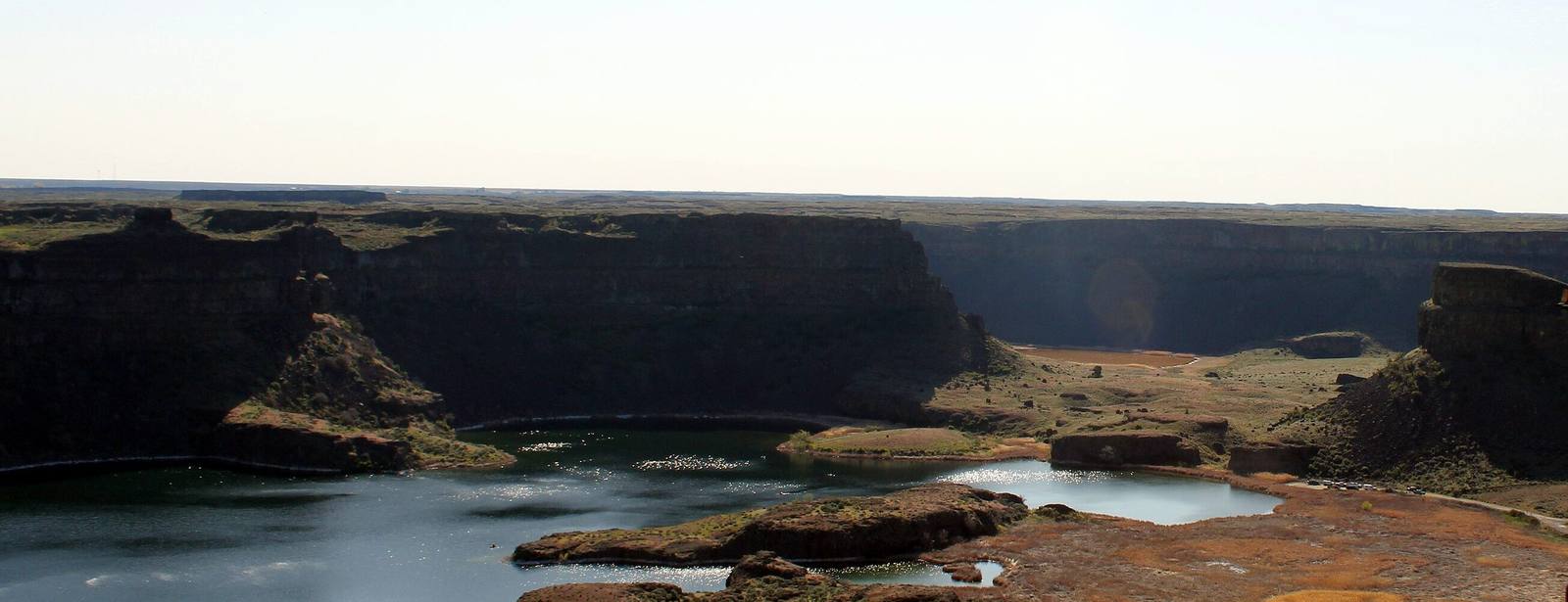 The basin of Dry Falls from the Vista House overlook, plunge pools and basalt islands below cliffs where the Ice Age floods once poured over a waterfall three and a half miles wide