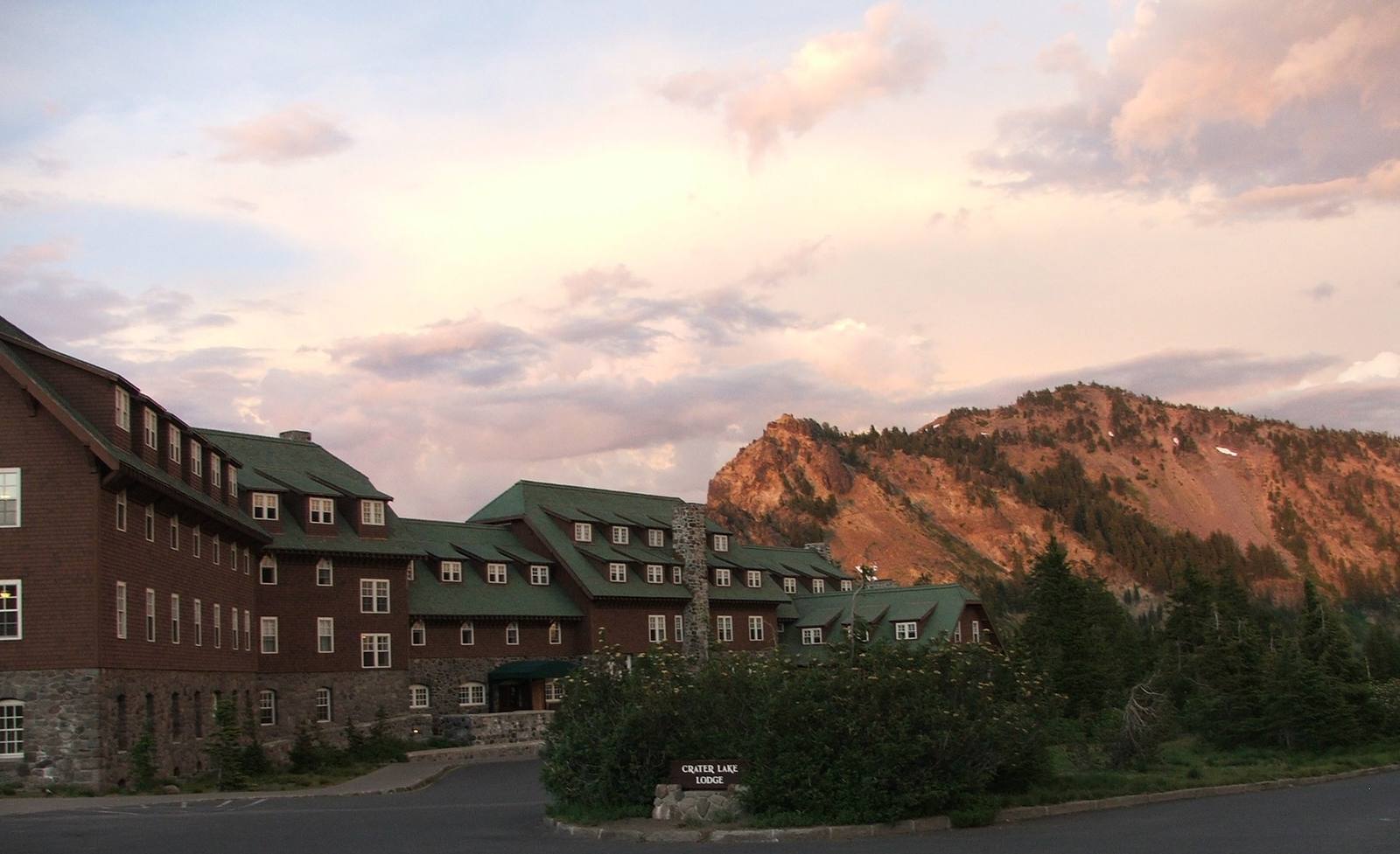 Crater Lake Lodge on the caldera rim at dusk, Garfield Peak glowing behind it