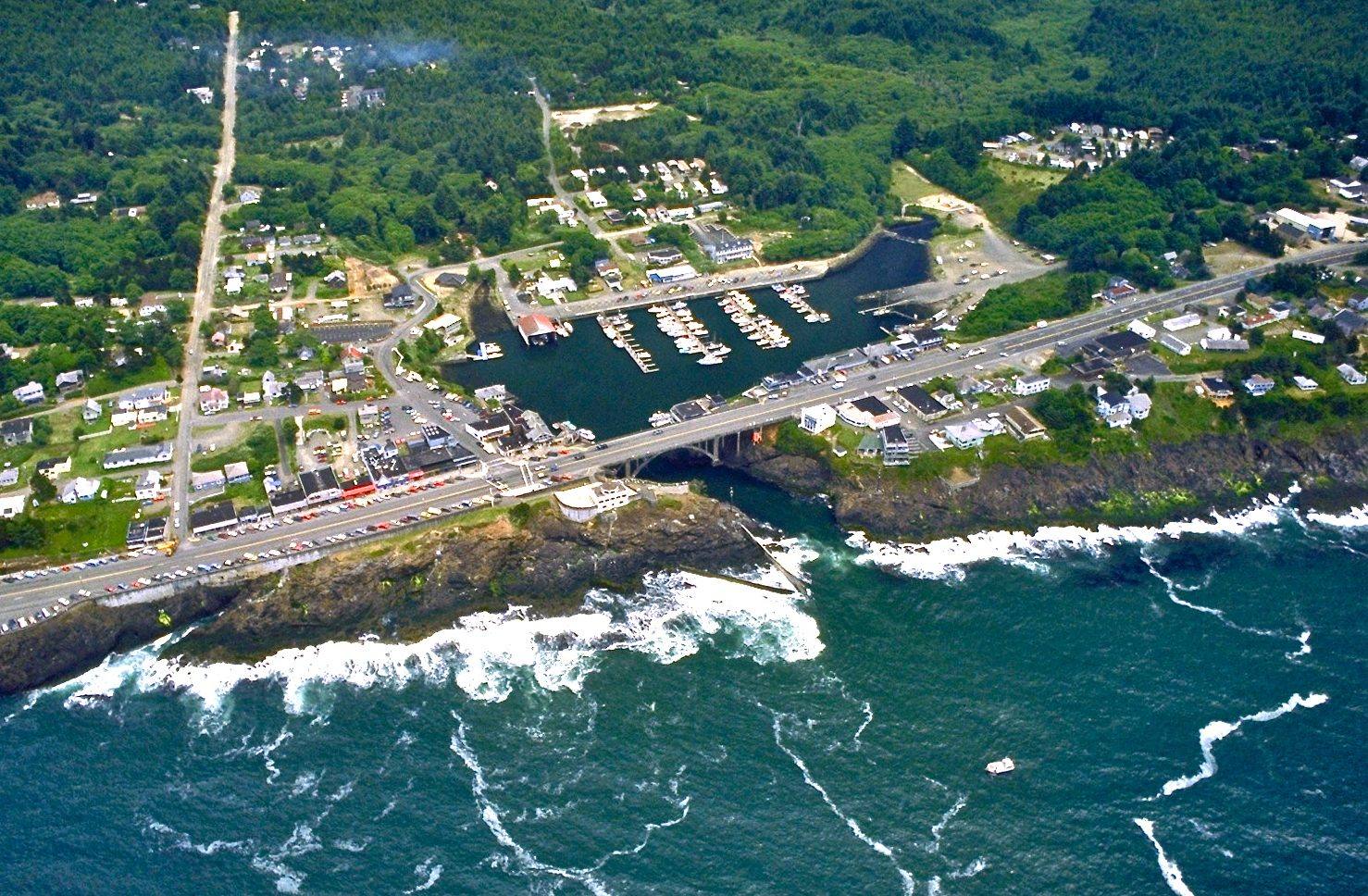 Aerial view of Depoe Bay, the small harbor reached through a rock channel under the US-101 bridge