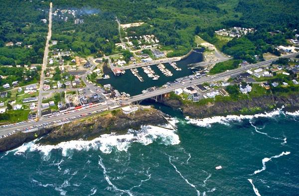 Aerial view of Depoe Bay, the small harbor reached through a rock channel under the US-101 bridge