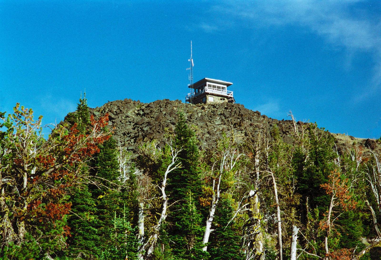 The fire lookout on the rocky summit of Heavens Gate above subalpine firs
