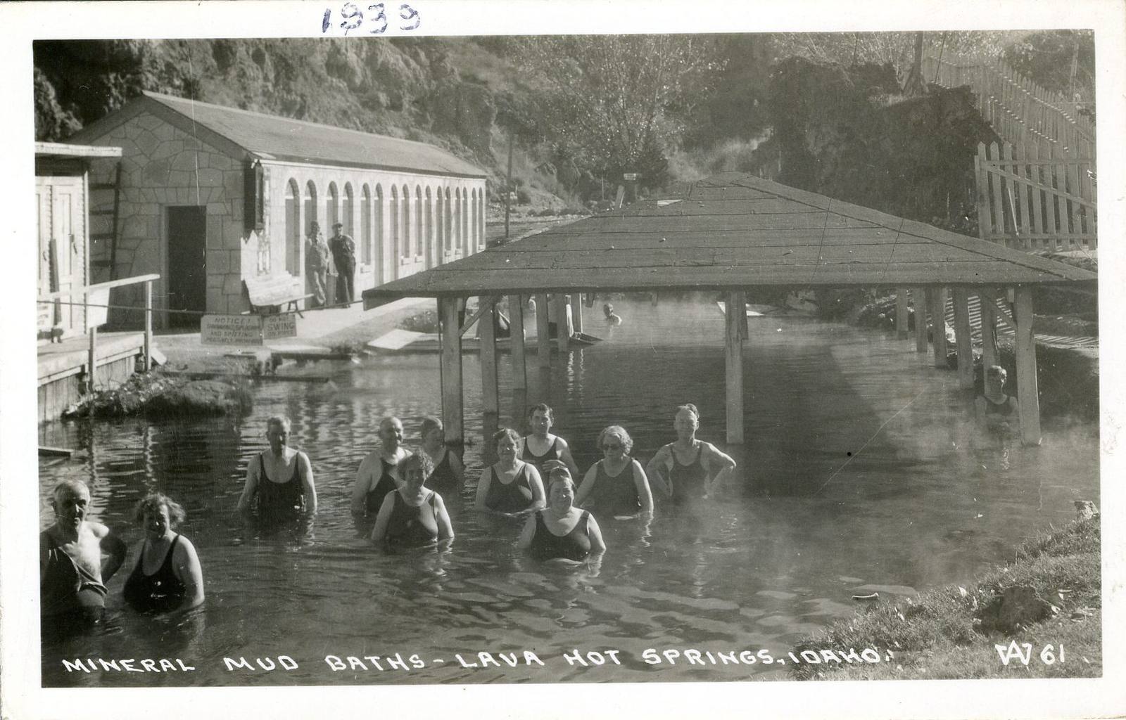 Bathers in the open mineral pool at Lava Hot Springs beside the bathhouse, in a 1939 real-photo postcard