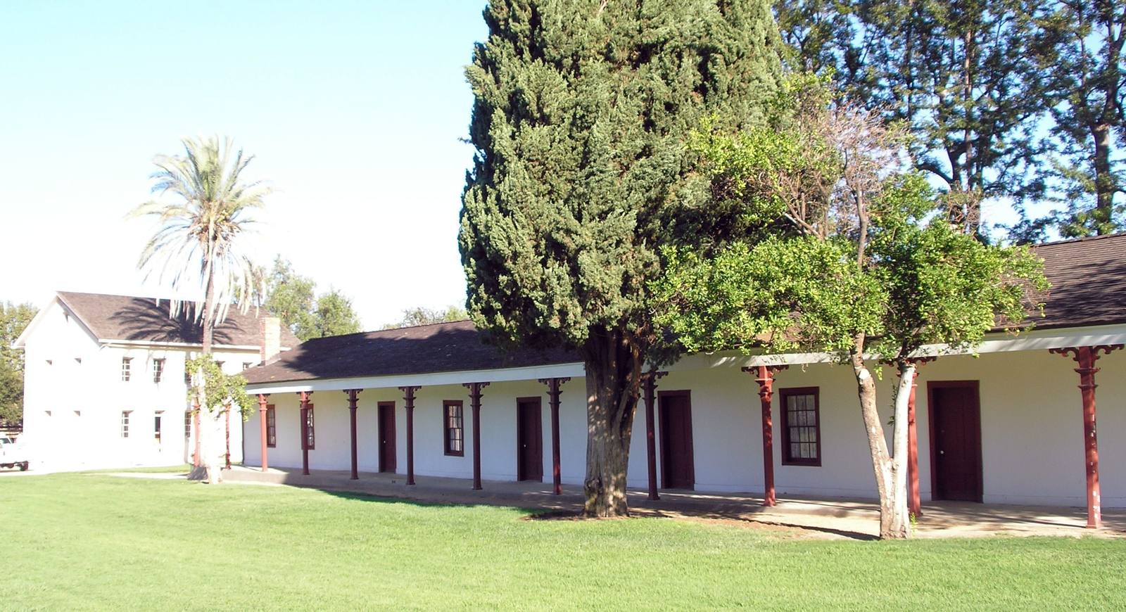The single-story de la Osa adobe at Los Encinos State Historic Park, with the two-story Garnier house behind it.