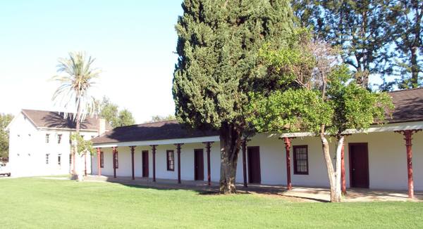 The single-story de la Osa adobe at Los Encinos State Historic Park, with the two-story Garnier house behind it.
