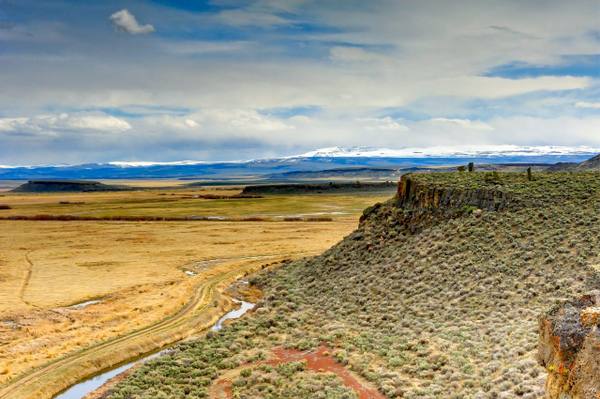 The Blitzen valley wetlands of Malheur National Wildlife Refuge from the Buena Vista overlook, Steens Mountain snowcapped beyond