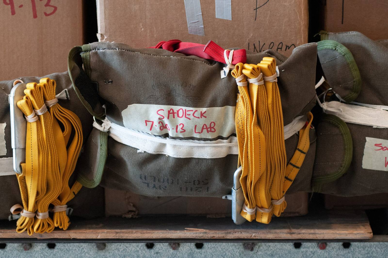 Canvas cargo bags with yellow straps packed for air drop at the McCall smokejumper base