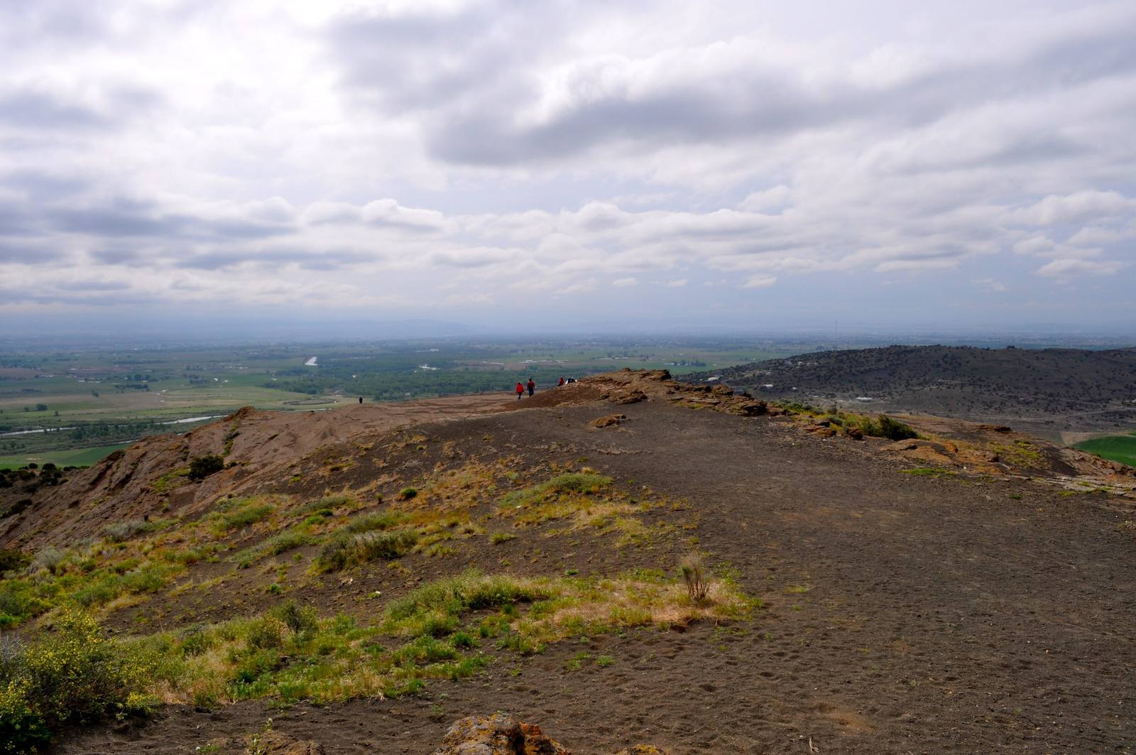 The trail along the crater rim of North Menan Butte, with farmland on the plain far below