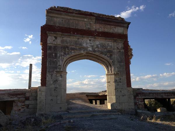 The brick and concrete arch of the ruined Lincoln School at Metropolis against a blue sky