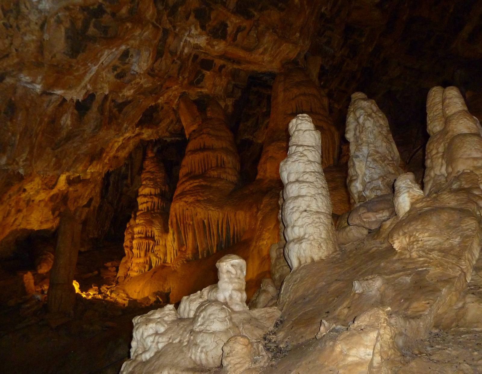 Pale stalagmites rising from the floor of a lit chamber in Minnetonka Cave