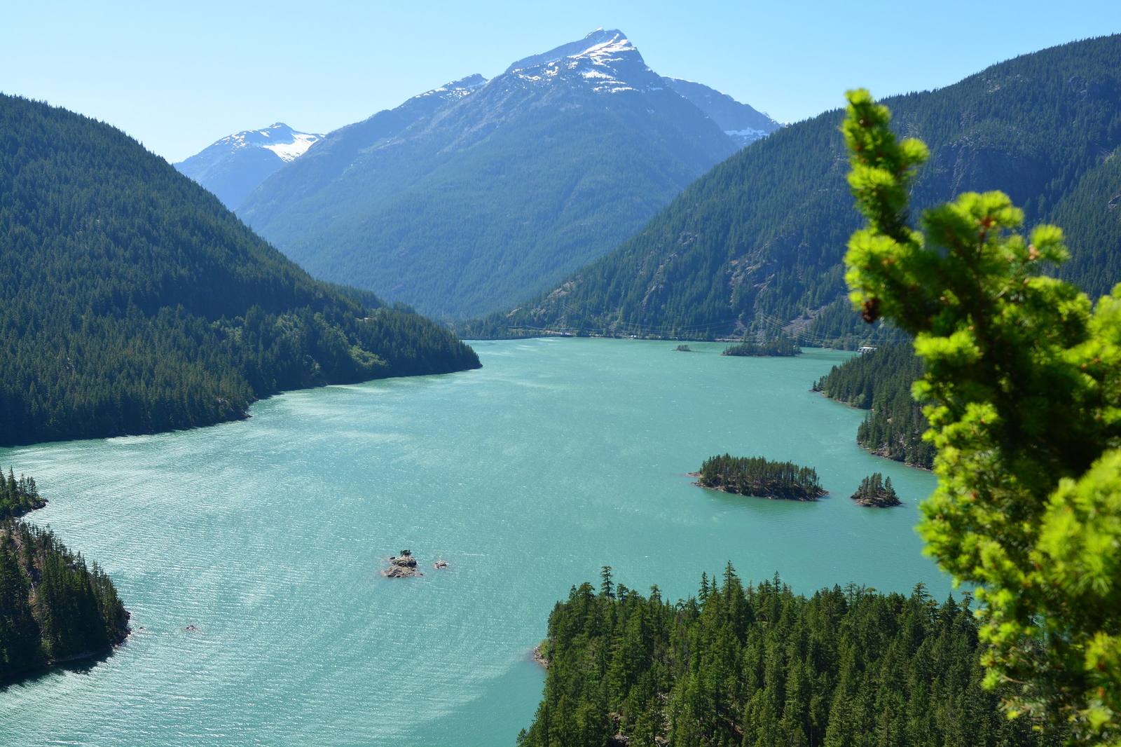The turquoise water of Diablo Lake from the overlook on State Route 20, Davis Peak rising beyond the forested arms of the lake