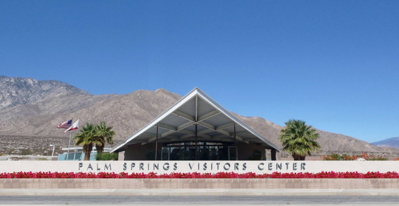 The Palm Springs Visitors Center — the 1965 Tramway Gas Station by Albert Frey and Robson Chambers — its cantilevered wedge roof against the bare slopes of Mount San Jacinto.