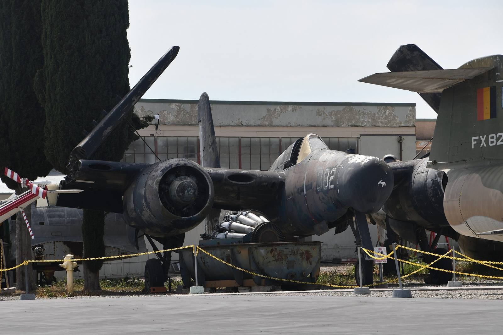 A Grumman F7F Tigercat parked nose-on among other aircraft outdoors at Planes of Fame in Chino.