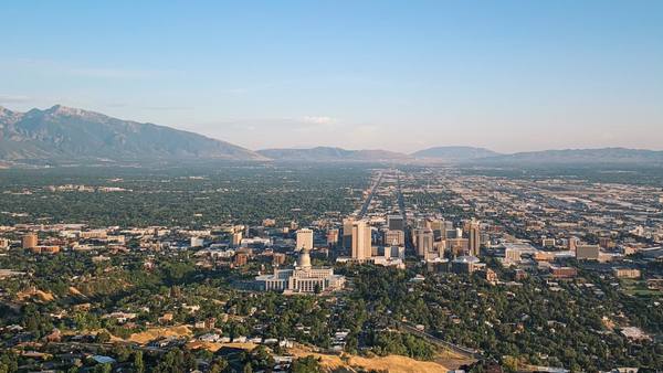 The Utah State Capitol and downtown Salt Lake City on the Bonneville benches, the valley spreading to the Wasatch and Oquirrh ranges — the basin dropped by the Wasatch Fault.