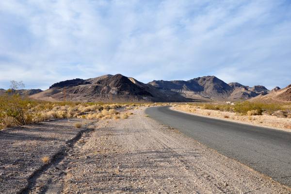 The pale rhyolite volcanic hills of the Bullfrog district in southwestern Nevada, rising along the road to the ghost town of Rhyolite.