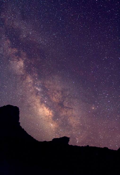 The core of the Milky Way rising over a silhouetted red-rock formation in the dark-sky country around Torrey, Utah, gateway to Capitol Reef.