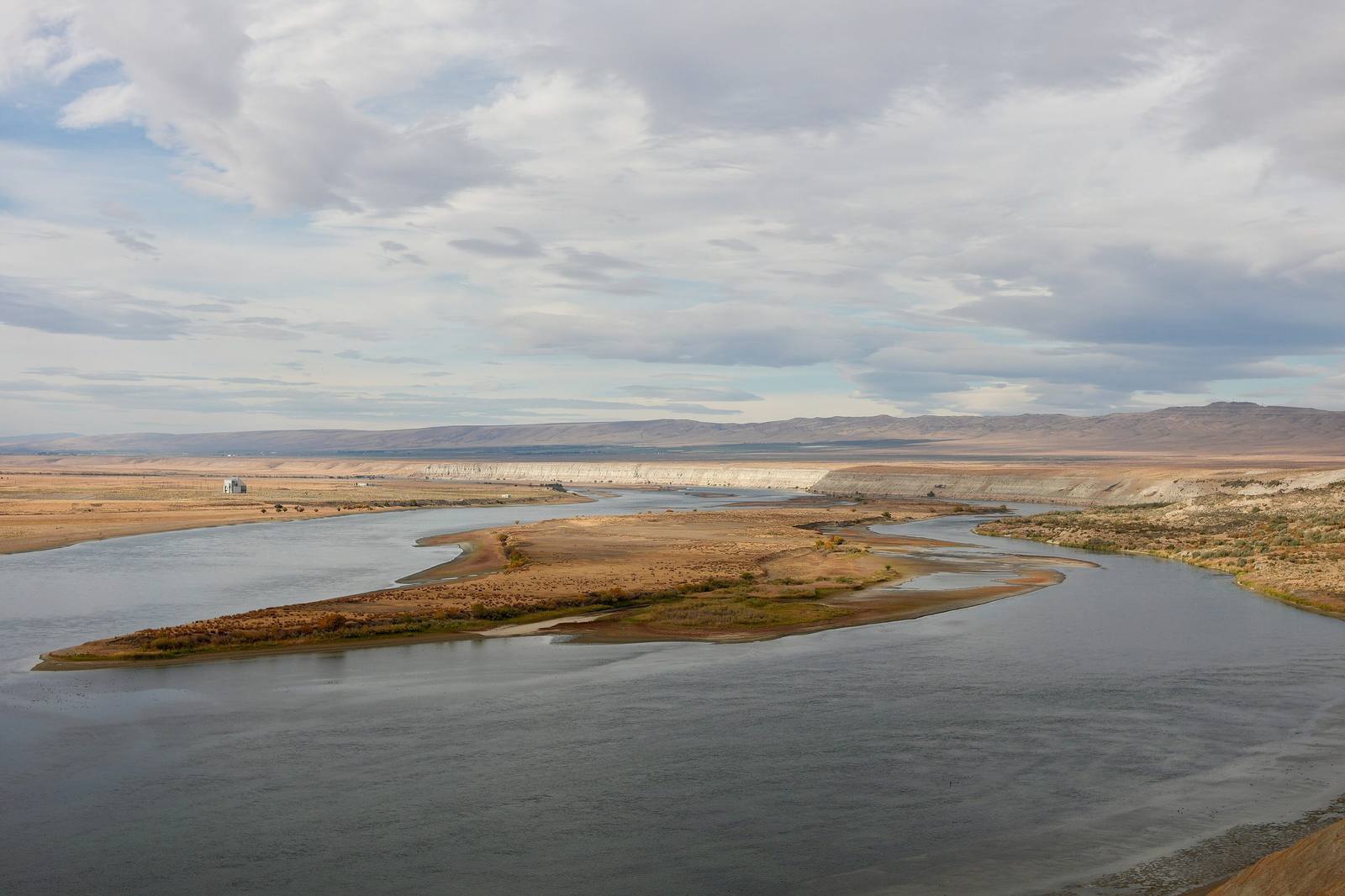 The free-flowing Columbia in the Hanford Reach, bending around gravel bars below pale bluffs