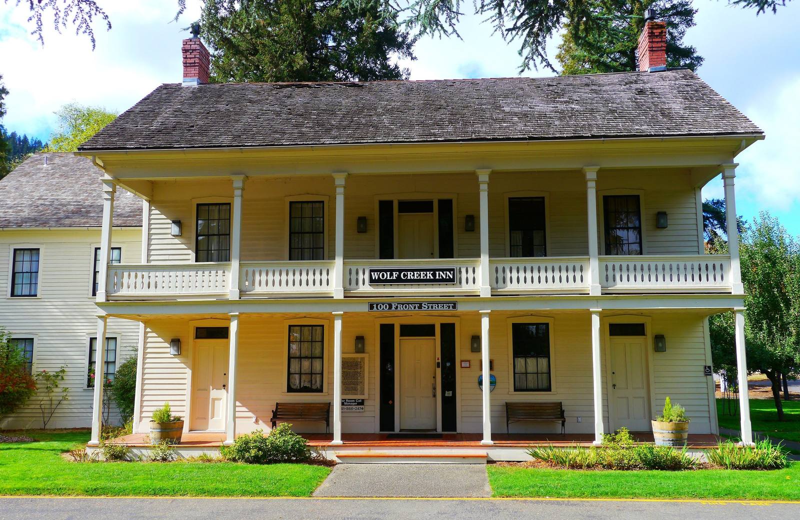 The Wolf Creek Inn, a two-story clapboard tavern with a full-length double veranda